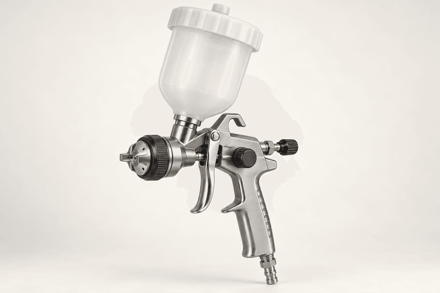Original brand-neutral illustration of a complete gravity-feed HVLP spray gun with cup, trigger, air cap and hose fitting.